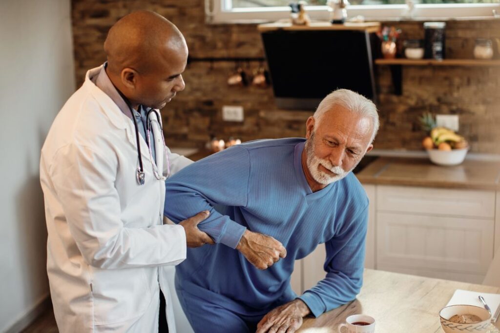 Doctor assisting senior patient. Doctor assisting senior man.