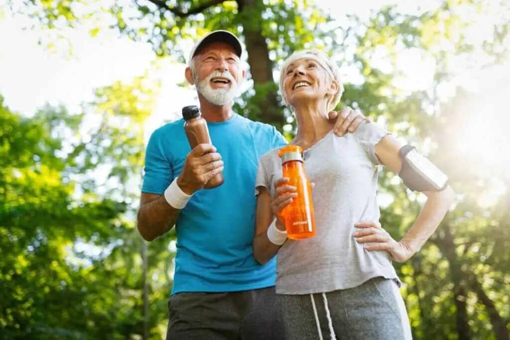 Elderly couple exercising outdoors.
