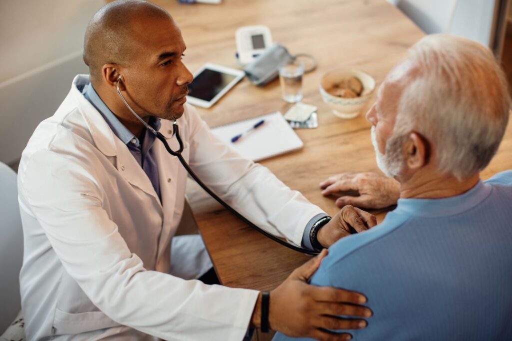 Doctor consulting elderly patient.