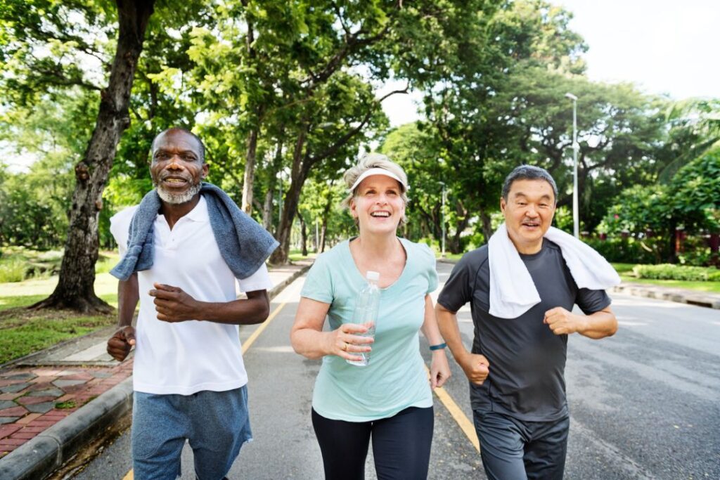 Seniors jogging in park.