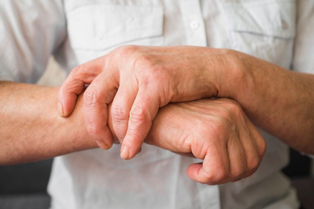 Elderly person's clasped hands.