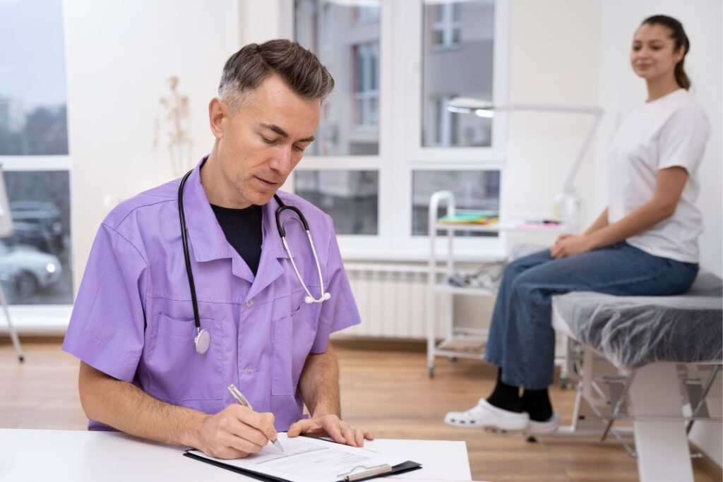 Doctor writing medical notes with patient.