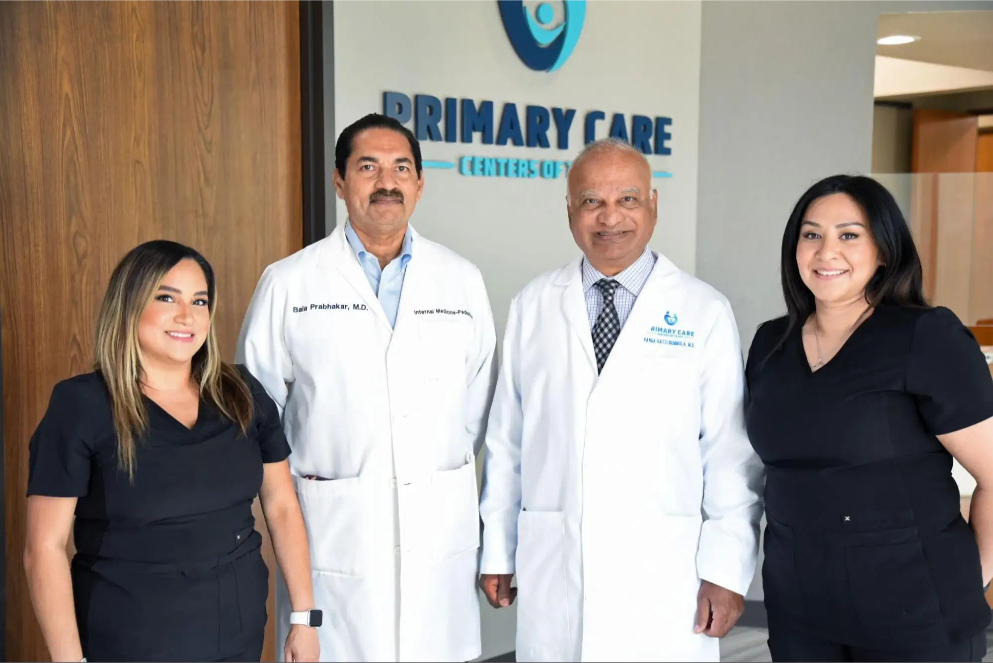 A group of medical professionals, including doctors and nurses, standing at the Primary Care Center of Texas.