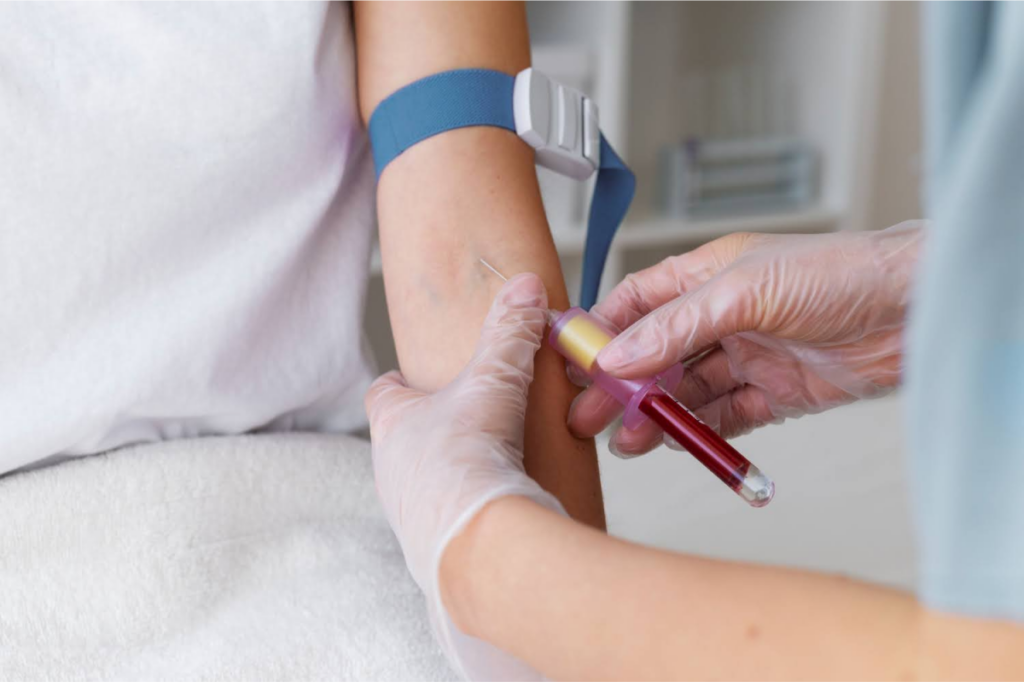 A healthcare professional drawing blood from a patient's arm.