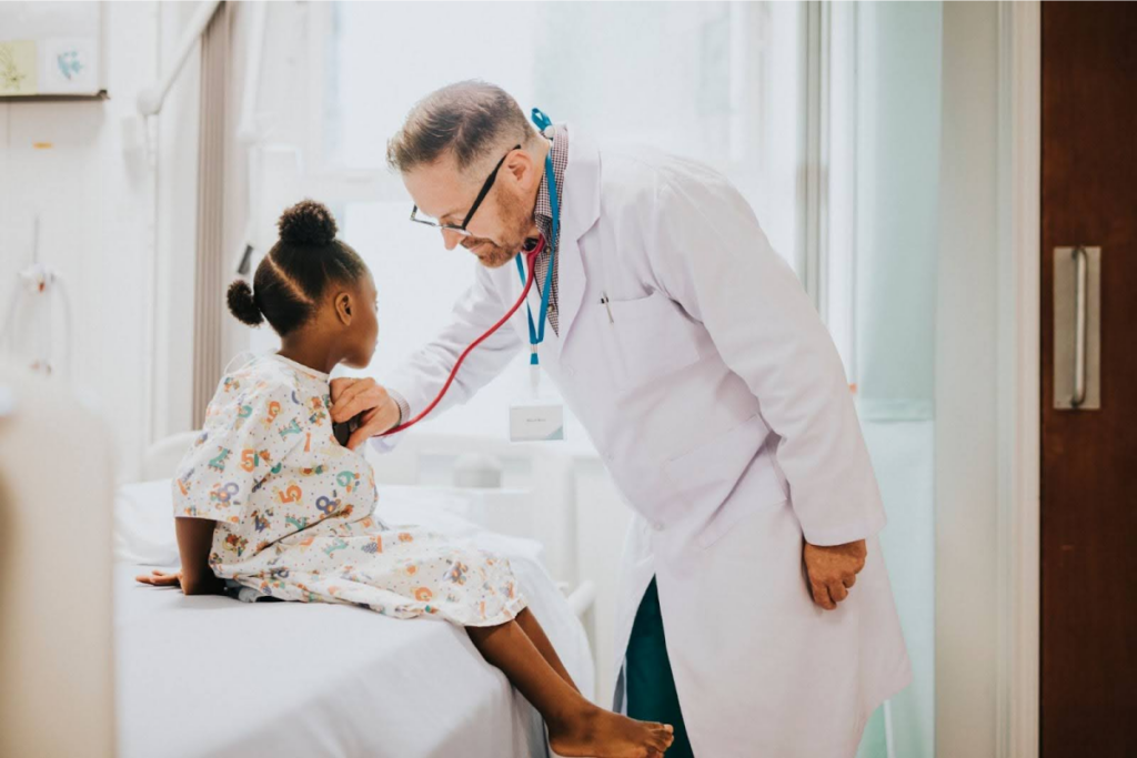 Doctor checking a child's heartbeat.