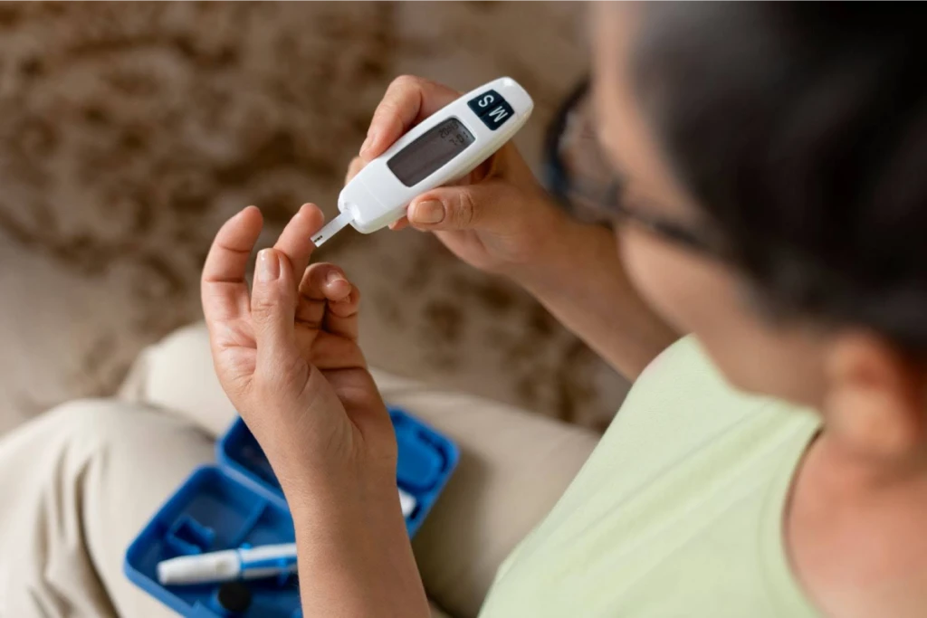 A close-up of a person using a glucometer to check their blood sugar levels.