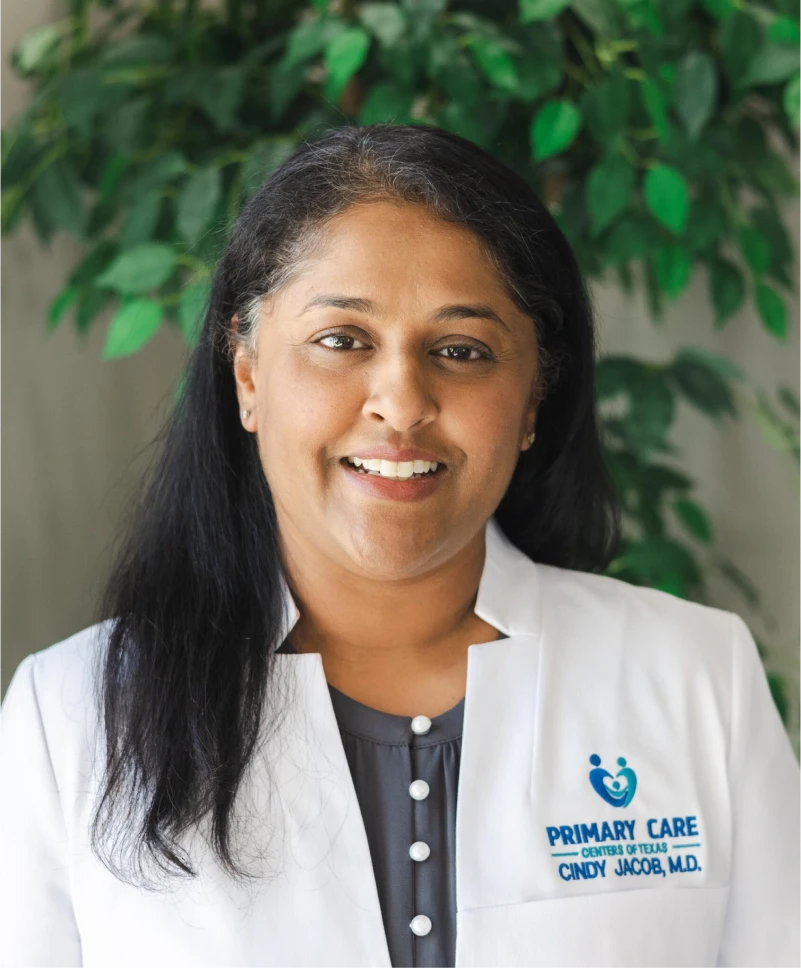 Smiling woman in a white medical coat