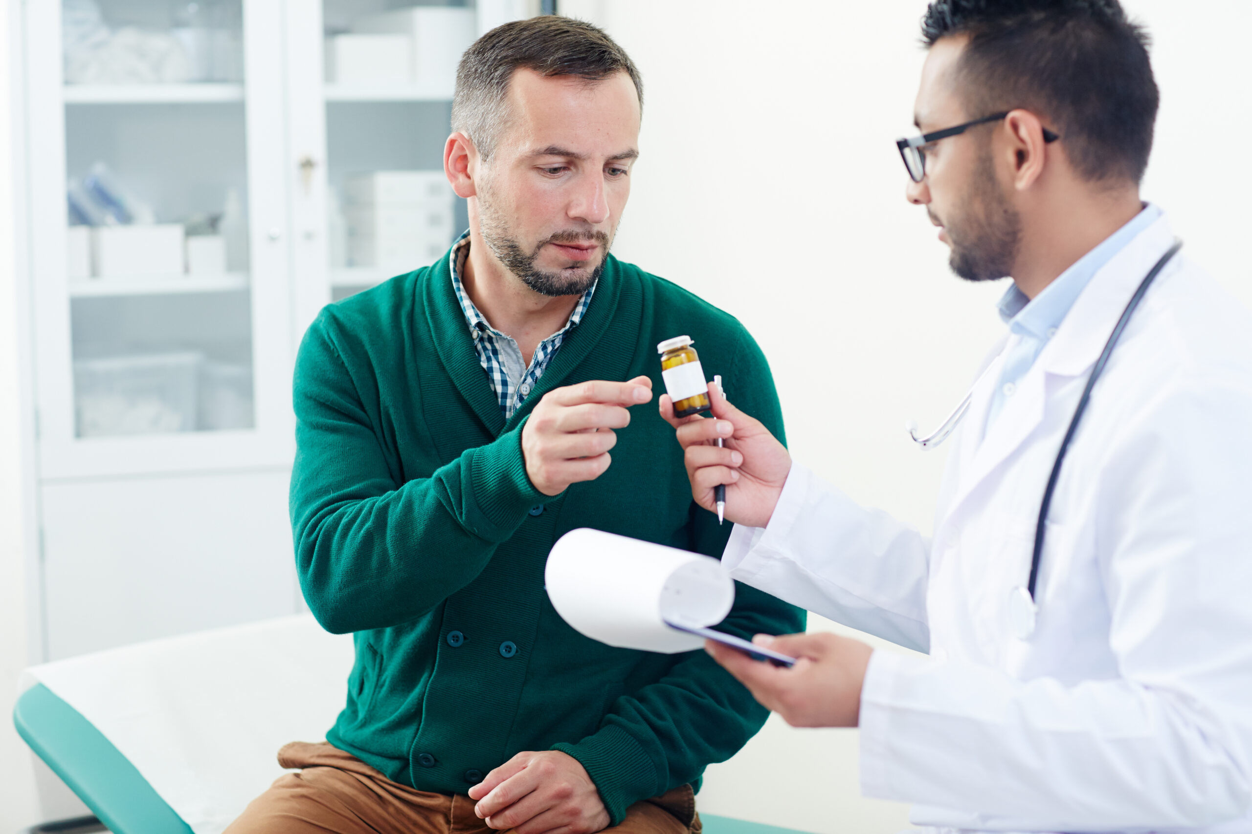 Doctor explaining Cholesterol Management​ medication to patient in clinic.