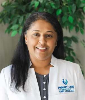 Smiling woman in a white medical coat